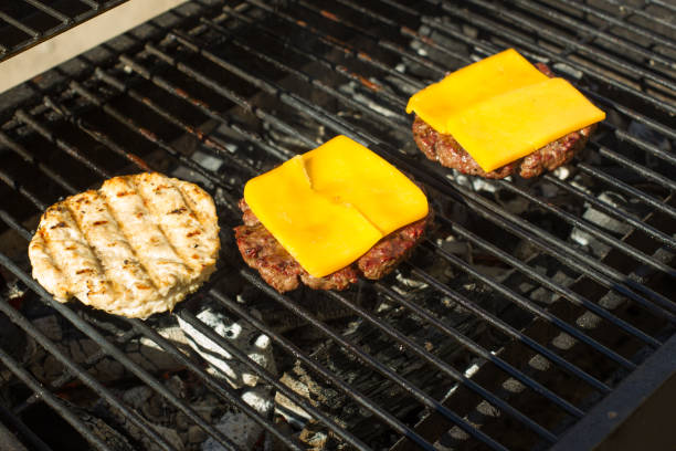 istock Meat cutlet from ground meat on the grill, cheese melts on top 906024776