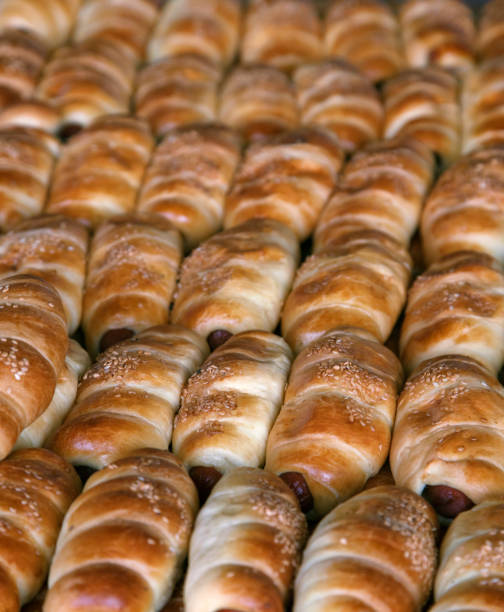 istock Sausages baked in dough on the tray 906024952