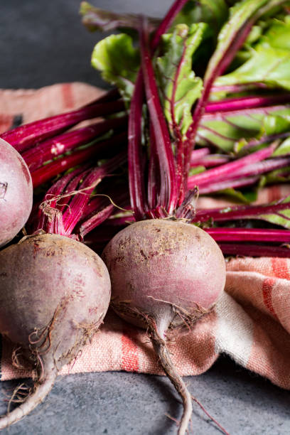 istock Young raw red beets roots with leaves 906024972