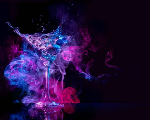 Photo of cocktail splashing in a smoky background