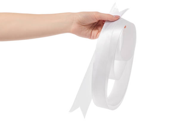 istock White ribbon decoration in hand 906029928