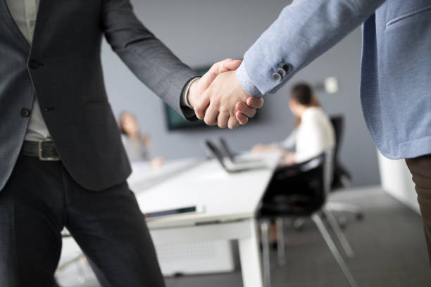 istock Business people shaking hands in modern office 906040750