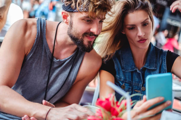 istock Couple looking at mobile phone in a coffee shop 906043026
