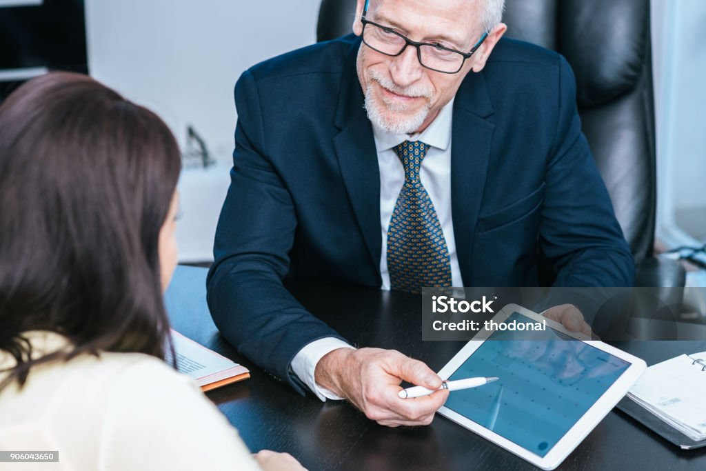 Woman meeting financial adviser in office Consultant advising young woman at office Financial Advisor Stock Photo