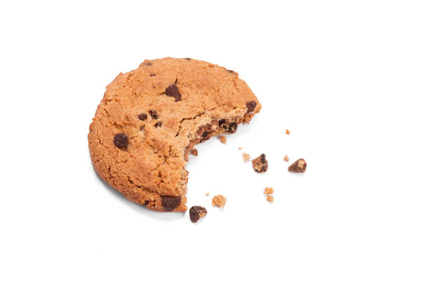 istock Single round chocolate chip biscuit with crumbs and bite missing, isolated on white from above. 906044234