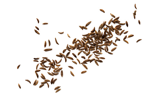 Cumin seeds or caraway on white background