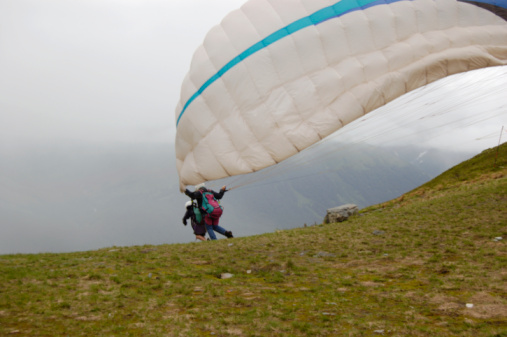 Paragliding near Tu Le valley, with landscape with green and yellow rice fields and  blue cloudy sky , North- Vietnam