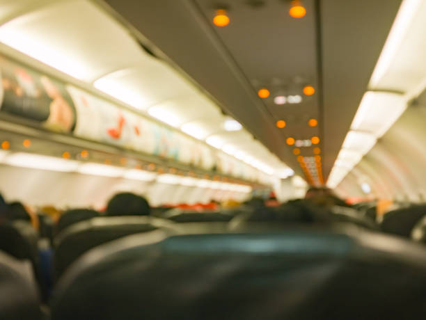 istock airplane 's interior , aircraft 's flight boarding passenger to their seat 906143056