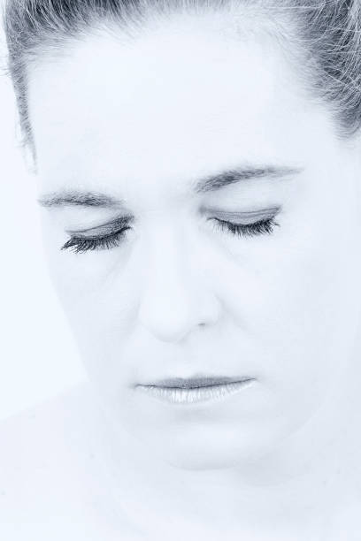 istock High key portrait of a woman with an empty expression on her face 906143230