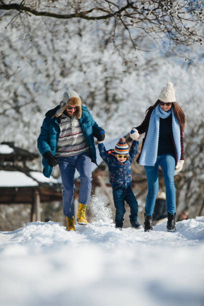 istock Family enjoying winter walk in the forest 906143270