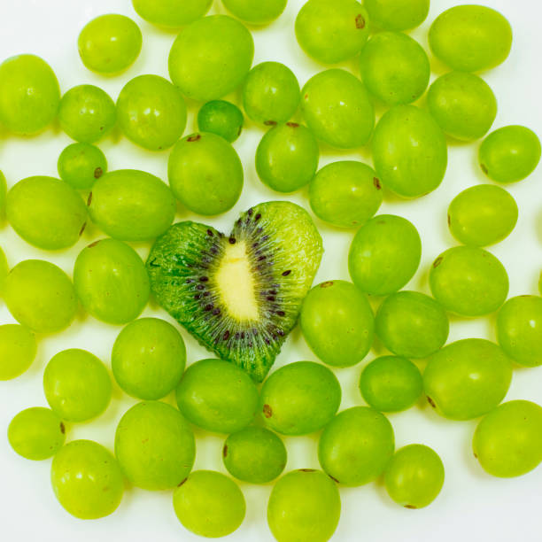herzförmiger kiwi - grape heart shape fruit bunch stock-fotos und bilder