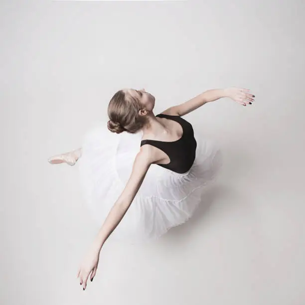 The top view of the teen ballerina on white studio background