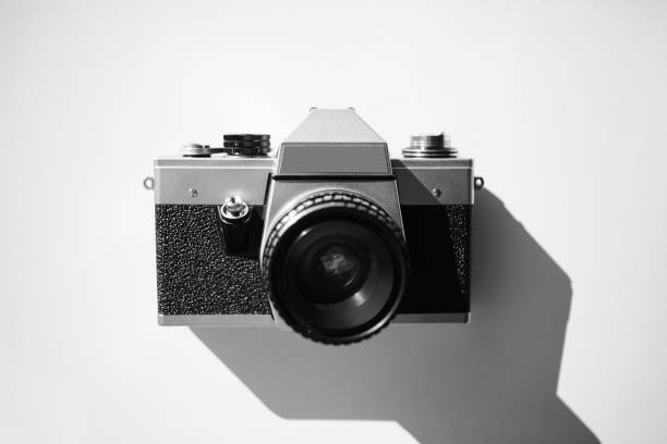 istock Old vintage film camera with lens on white background 906147262