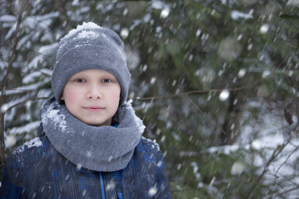istock A boy walks in the forest in winter 906147716