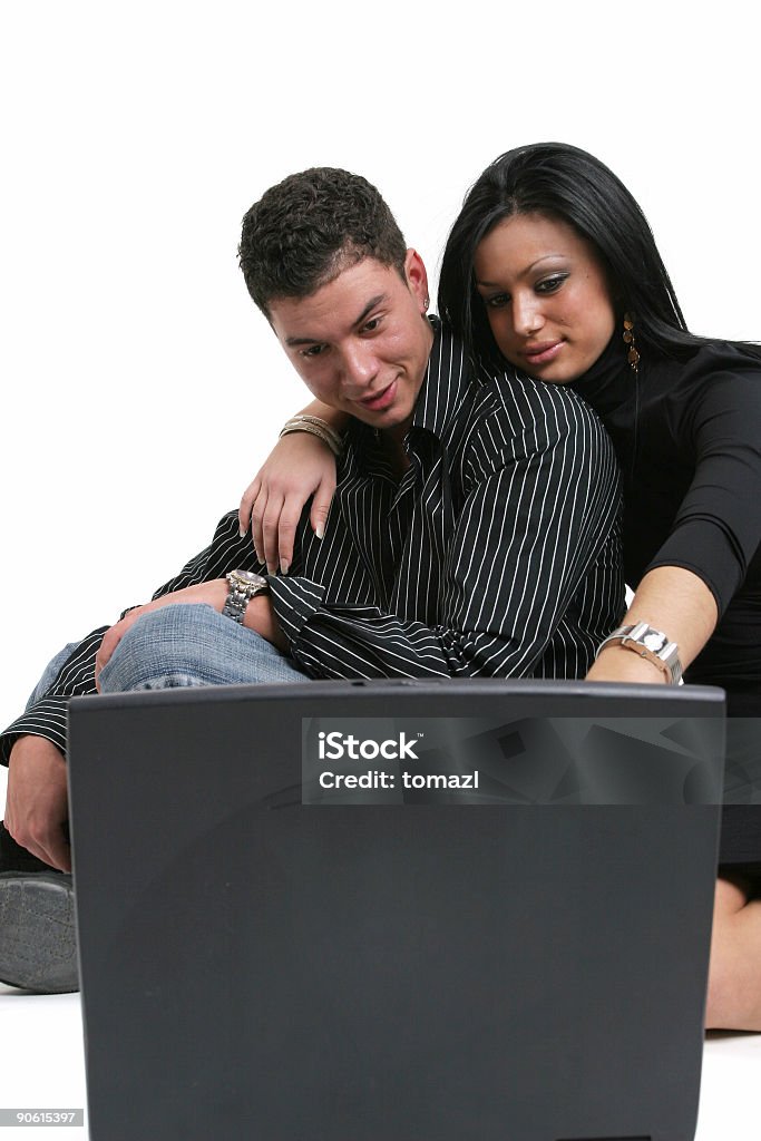 Couple with computer Young adult man and woman looking at laptop computer. Accessibility Stock Photo