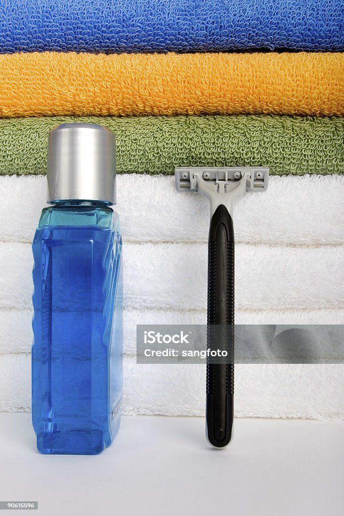 Aftershave and Razor men's aftershave and razor with bath towels in the back Aftershave Stock Photo