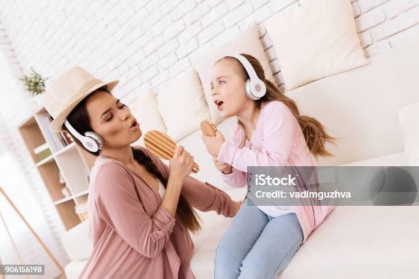 Mom And Daughter Sing Songs At Home Stock Photo - Download Image Now - Mother, Singing, Family