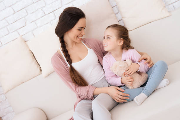 istock Mom and daughter together on the couch. 906159134