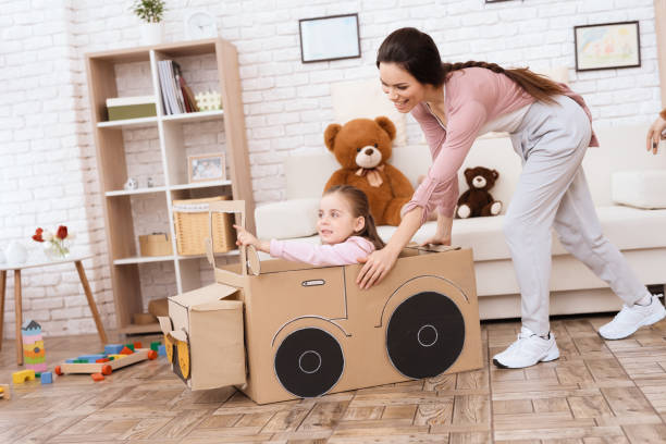 a little girl with her mother is playing with a toy car. - family mother domestic life food imagens e fotografias de stock