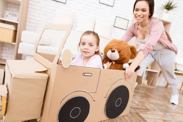 a little girl with her mother is playing with a toy car. - family mother domestic life food imagens e fotografias de stock