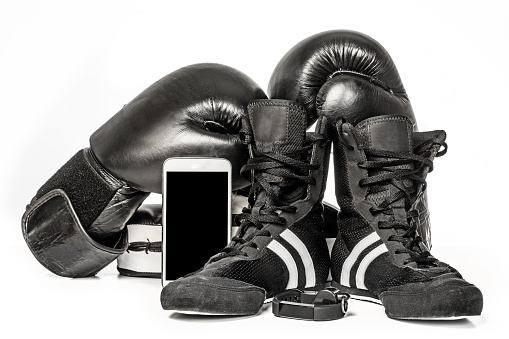 Sports boxing and combat sport equipment with wireless tracking device on white background