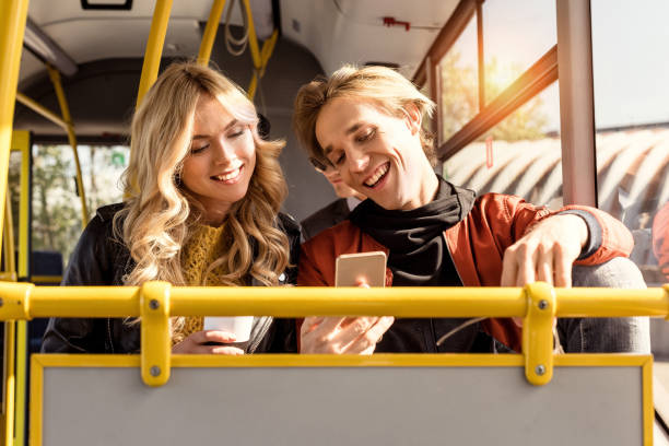 istock couple with smartphone in public transport 906192640