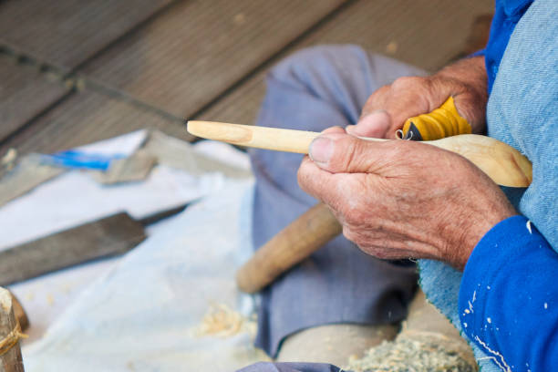 on the street Istanbul old man makes a wooden spoon