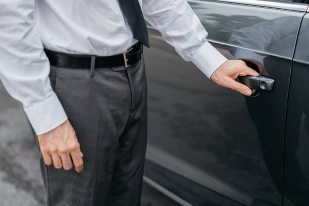 istock Businessman opening a car door 906197648