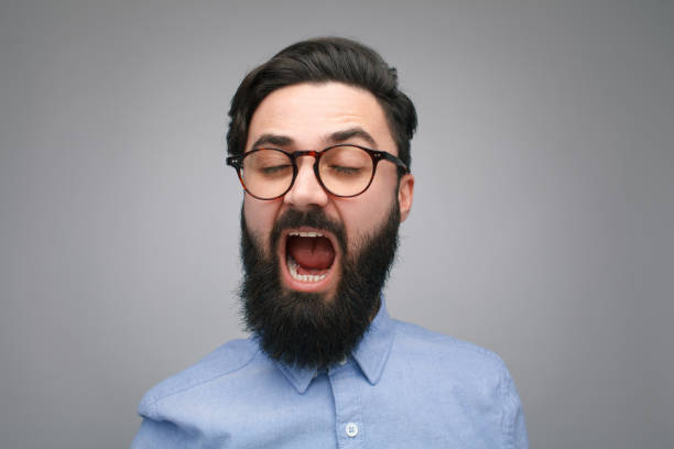 istock Bearded man in glasses yawning 906200482