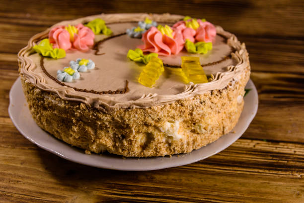 istock Kiev cake with cream on wooden table 906200772