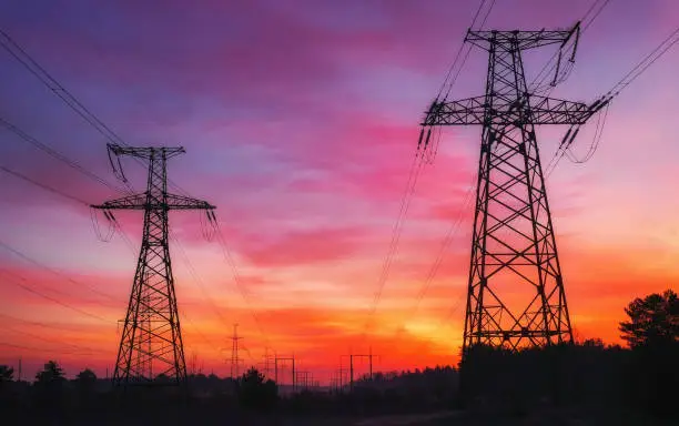 Photo of High-voltage power lines during fiery sunrise