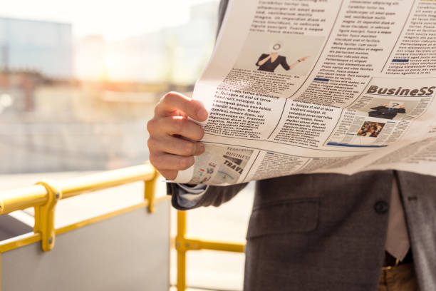 istock man with newspaper in bus 906204258