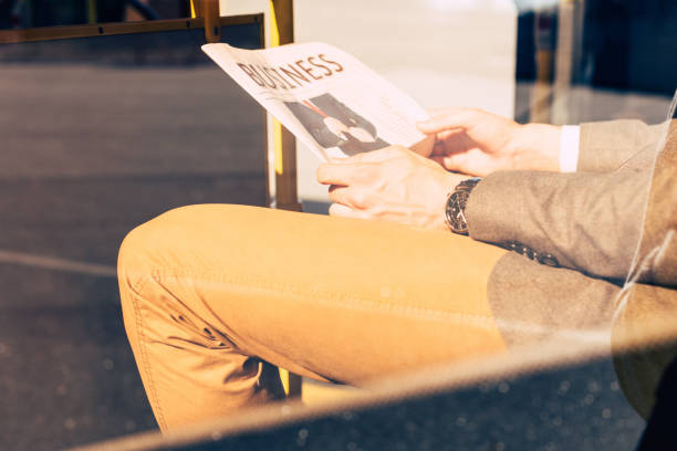 istock man with newspaper in bus 906204426