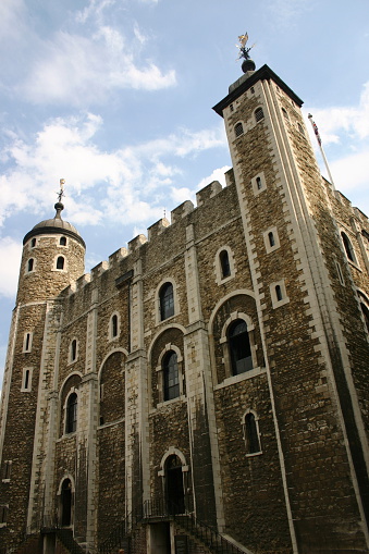 Panoramic view of the Tower of London with outer wall and moat, Tower Bridge and Skygarden in the background