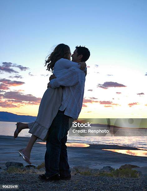 Soul Mates Embracing During Sunset Stock Photo - Download Image Now - Adult, Beautiful People, Beautiful Woman