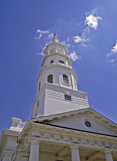 istock church steeple in white puffy clouds 90627959
