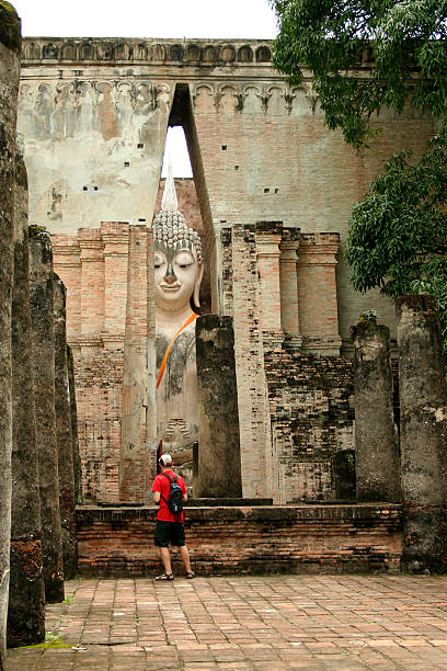 istock tourist before big buddha Sukhothai thailand 90628184