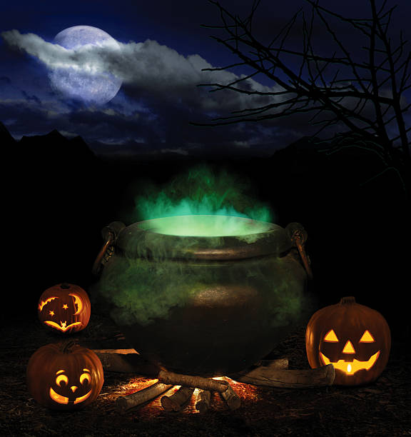istock A glowing green cauldron and jack-o-lanterns 90629873