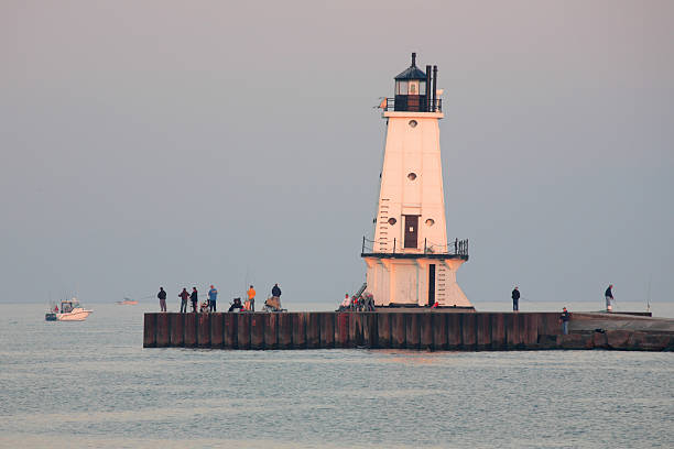 istock Fishing Pier, Fisherman and Lighthouse 90631349