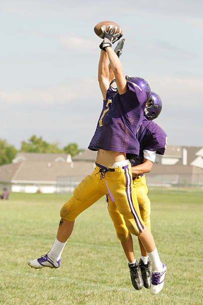 istock Leaping Catch at a football game 90631559