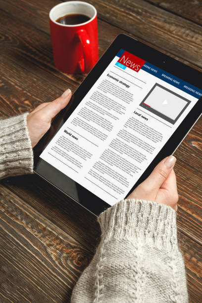 istock Woman reading news on tablet 906331262
