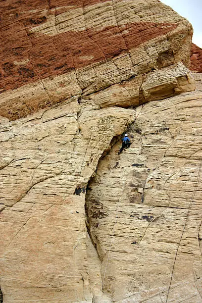 a female climber makes her way to the top of Red Rock Canyon