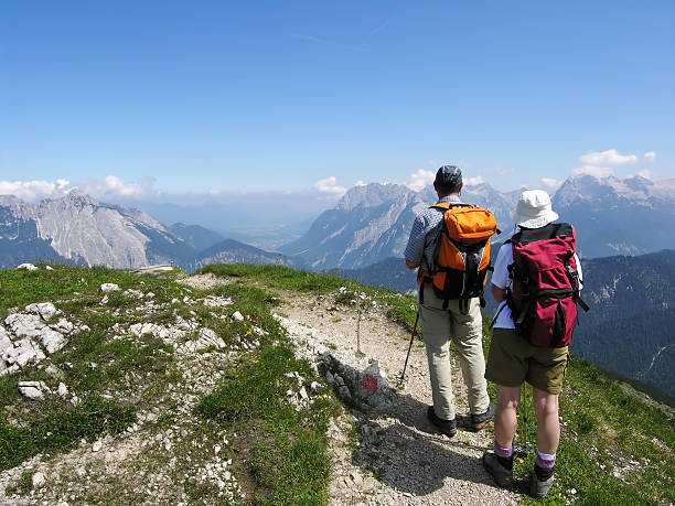 Hikers up on mountain enjoying view before going back down  stock photo