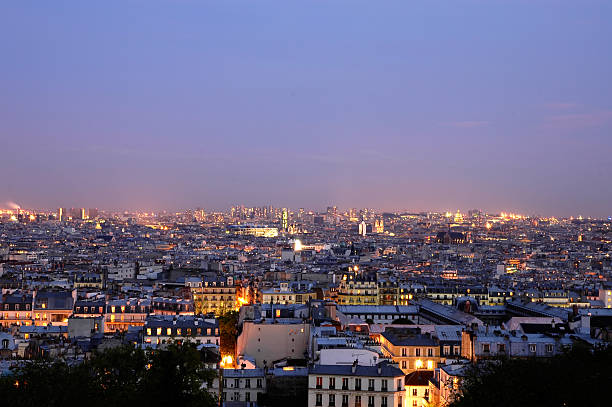 View of  the city of Paris at night from Montmartre district, on January 27, 2024.