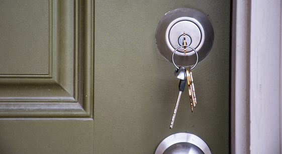 Keys inside Front Door of New Home ownership and real estate bubble