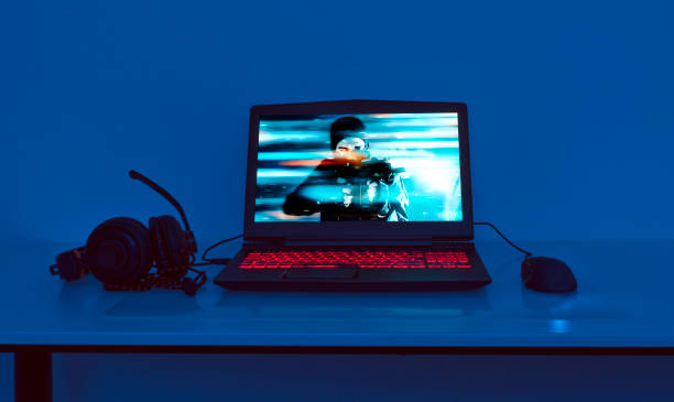 istock Gaming laptop with connected mouse and headphones 906345562