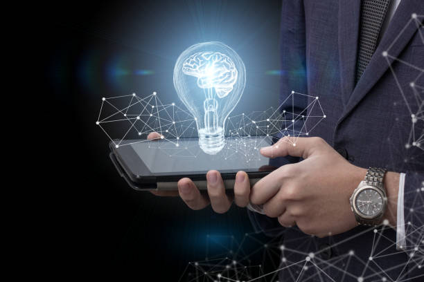 istock Light bulb with brain of the tablet. 906345740