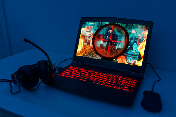 istock Gaming laptop with connected mouse and headphones 906347948