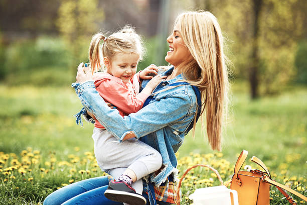 istock Mother and daughter in the park 906354248