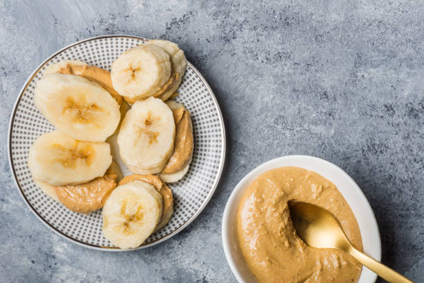 Light Healthy Snack made from Banana Slices and Cashew Butter stock photo